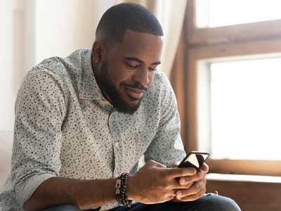 A man taking a health risk assessment on his phone