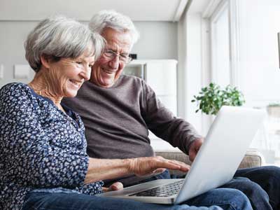 A man and woman taking a stroke assessment on their laptop