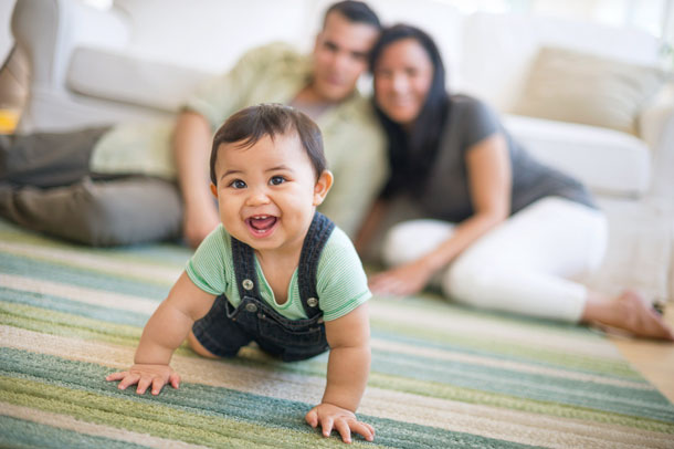 Family together with baby crawling